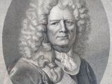 portrait of a man with long curly hair and a bow tie
