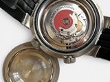 a close up of a watch on a white surface