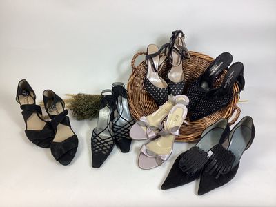 several pairs of women ' s shoes in a basket on a table