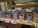 many rolls of thread on a shelf in a store