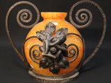 a vase with a design on it sitting on a table