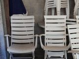 many white chairs and a table in a room
