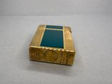 a gold lighter that is sitting on a table
