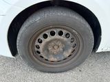 a close up of a tire on a white car