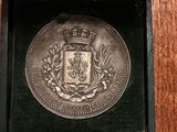 a close up of a medal in a box on a table