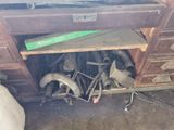 a pile of assorted metal pipes and pipes in a garage
