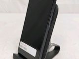 a cell phone that is sitting on top of a stand