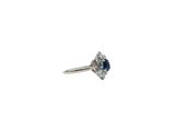 a close up of a diamond and sapphire ring on a white background