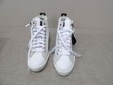 a pair of white sneakers with black and white laces on them