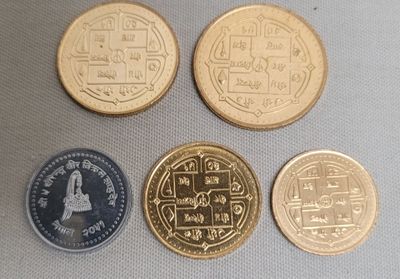 four different types of coins sitting on top of a table