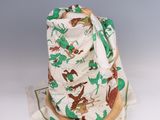 a white hat with a green and brown design on it