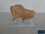 a statue of a bird on a stand on a table