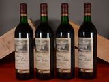 three bottles of red wine sit on a table next to a wooden box