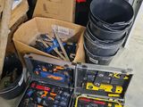 many tools in a box on the floor in the garage