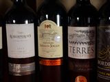 several bottles of wine are lined up on a table