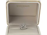 a close up of a ring in a box on a white surface