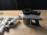 a coffee maker sitting on a table next to a pair of scissors
