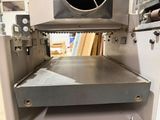 an image of a machine that is being used to make pizzas