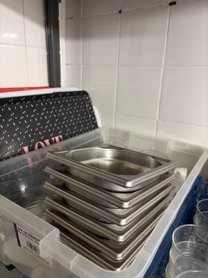 a stack of pans sitting on top of a plastic container