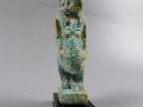 an ancient statue of a woman holding a baby in her arms