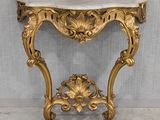 an antique console table with a marble top and gold leaf decoration