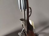 an old gun is sitting on top of a desk next to a mouse