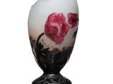 un vase blanc orné d'une fleur rose