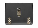 une boîte noire ornée de perles et d'un emblème en or
