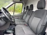 the interior of a van with a steering wheel and seat covers