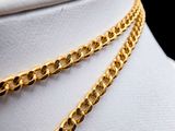 a close up of a gold chain necklace on a mannequin