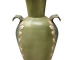 a green vase that is sitting on a white surface