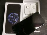 an image of a cell phone in a box with earphones