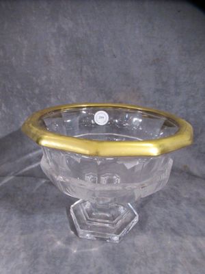 a glass bowl with a gold rim sitting on a table