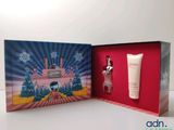 a box with a bottle of perfume and a bottle of lotion in it