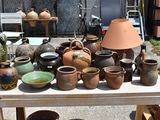 many different types of pottery sitting on a table
