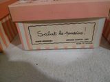 a pink box with a label on it sitting on the floor
