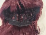 a woman with red hair and a black hat on