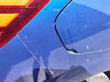a close up of a car ' s tail light and the rear end of the car