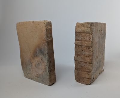 two pieces of stone are sitting next to each other on a white surface