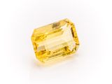 a yellow sapphire stone on a white background