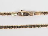 two gold chains are shown on a white surface, one has a clasp and the other has a clasp