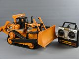 a toy bulldozer next to a radio on a table
