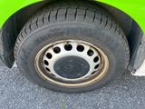 a close up of a tire on the side of a green car