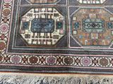 a rug with a pattern on it on a wooden floor