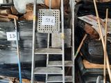 a pile of trash in a garage with a ladder