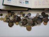 a lot of coins on the table next to an open book
