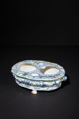 blue and white porcelain plate with two bowls on top of it