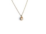 a gold necklace with a small white stone on a gold chain