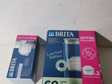 two boxes of toothpaste sitting on a table next to each other