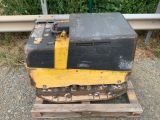 a yellow and black bulldozer sitting on a pallet